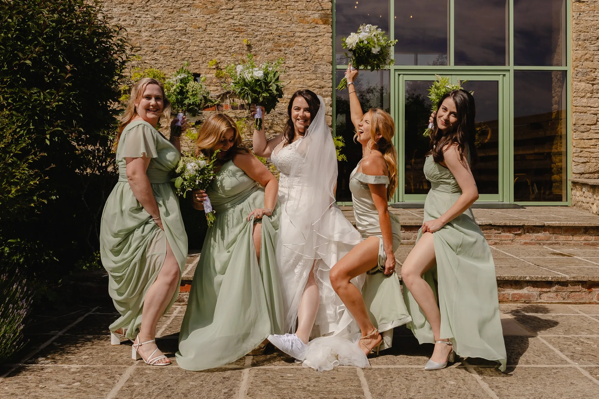 Bride with bridesmaids at The Great Barn Aynho