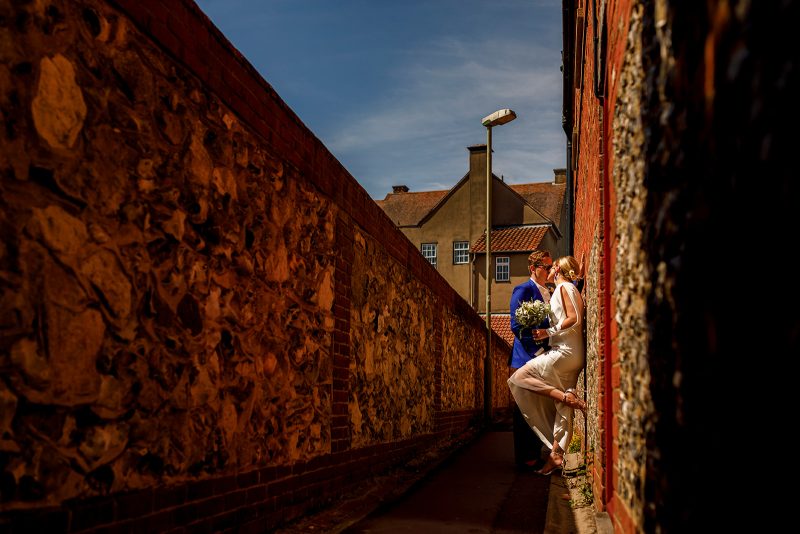 Bride and groom walking through the streets of Wallingford during their micro wedding for relaxed natural couple portraits